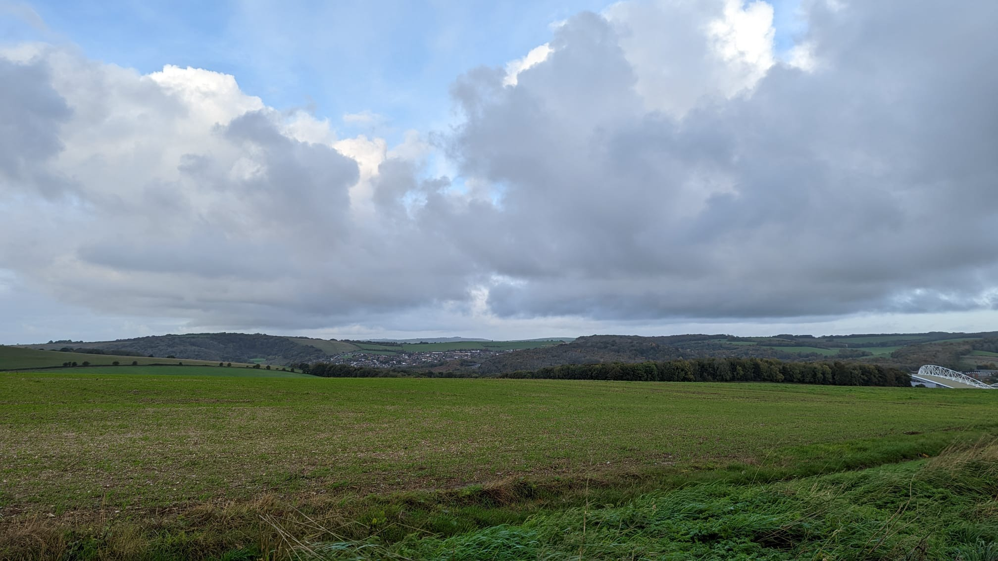 The grey clouds hanging above the South Downs and the woodlands. Just visible in the bottom right is the top of the Brighton & Hove Albion stadium.